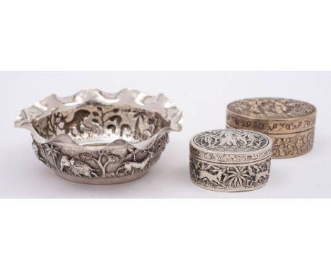 An Indian silver sugar basin: of circular form with embossed  jungle scenes, 10cm diameter, together with an Indian silver ov