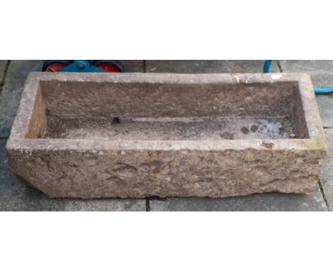 A rough hewn rectangular stone trough, 18th/ 19th century;: 25cm high, 101cm long, 41cm wide.