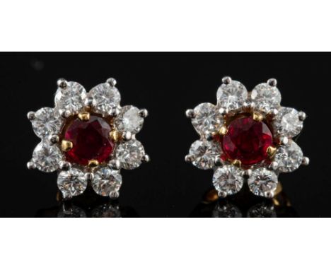 A pair of 18 carat gold ruby and diamond earrings by Garrard & Co.,: the circular cut rubies claw set within a removable surr