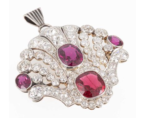 An Edwardian style ruby, red spinel and diamond brooch/pendant, the fan design piece having a central ruby with radiating mil