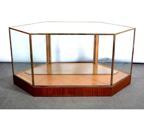 Brass framed plate-glass display counter, with angled ends, fitted with a single plate-glass shelf, oak quartered veneered ba