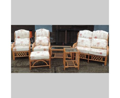 A bamboo conservatory suite, comprising a two seater sofa, 118cm, two chairs, two tables and a footstool