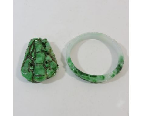 A jade coloured carved hardstone pendant, 7cm, together with a bangle