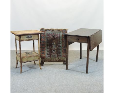 A George III pembroke table, together with a firescreen, majolica stand and a Victorian bamboo cabinet