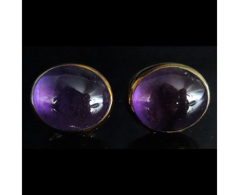A pair of unmarked gold and amethyst cabochon earrings
