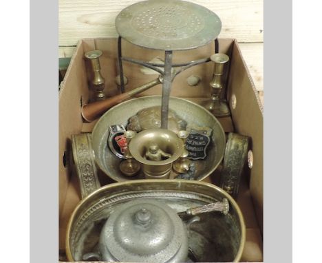A box of metalwares, to include a brass jardiniere, with hammer beaten decoration, car badges and brass candlesticks