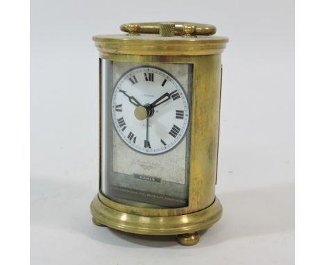 A reproduction brass miniature carriage clock, 9cm tall