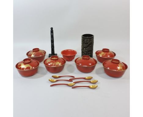 A set of six oriental lacquered tea bowls, another, a carved totem pole figure and a brush pot, 15cm tall