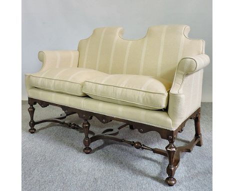 An early 20th century Queen Anne style walnut and cream upholstered sofa, 144cm