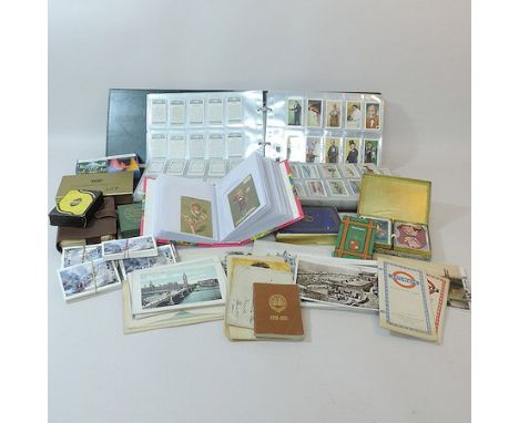 A collection of cigarette cards, together with vintage postcards and playing cards