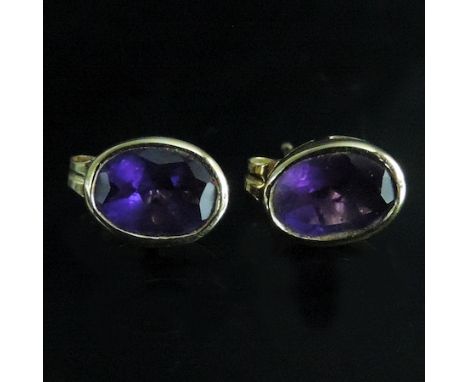 A pair of 18 carat gold and amethyst stud earrings