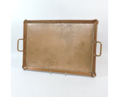 An Arts and Crafts style copper tray, with hammer beaten decoration, stamped Olbury, 53cm