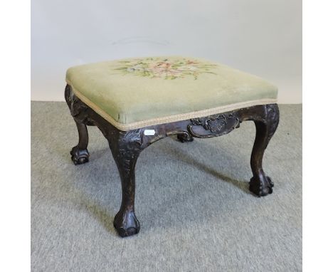 An early 20th century carved and tapestry upholstered footstool, on cabriole legs, 56cm 