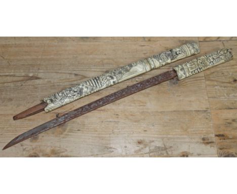 A Japanese bone short sword, length 60.5cm.  Condition - end of scabbard missing.