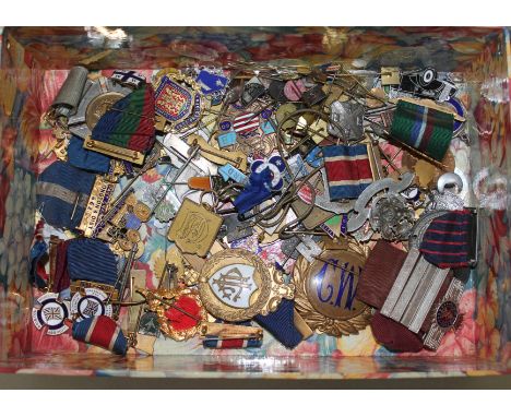 A box of vintage enamel badges.  