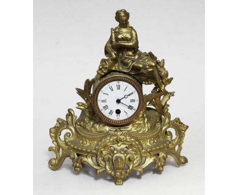 A French gilt metal figural mantel clock with key and pendulum, height 32cm.
