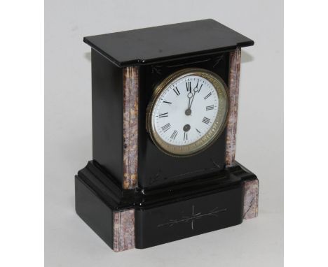 A black slate and marble mantel clock with pendulum, height 24cm.  