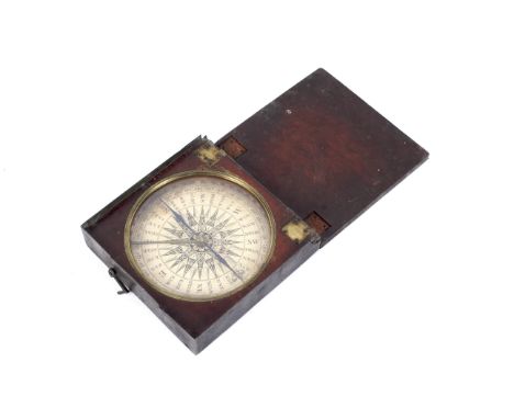 A 19th century mahogany cased travelling compass. With square case enclosing a compass with printed paper dial and blued stee