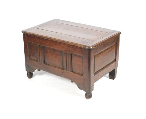 An early 18th century smaller oak coffer with rounded corners, three panel front,  ball feet , wire hinges and dowel construc