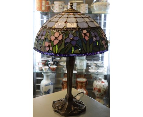 Reproduction Tiffany style table lamp with foliate glass panel shade on cast metal base. 62cm high approx.(B.P. 24% incl. VAT