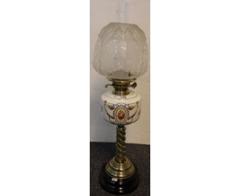 Early 20th Century brass double burner oil lamp with transfer printed ceramic reservoir on a spiral brass column with ceramic