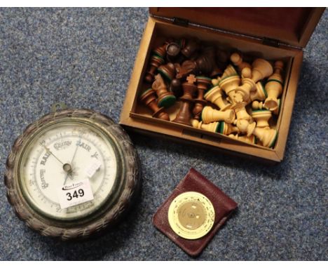 Eastern carved wooden box containing Staunton type chess set, small aneroid barometer and brass weather forecasting disk. (3)