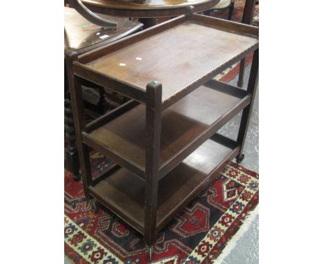 Early 20th Century oak gate legged table, together with an early 20th Century three tier trolley on wheels. (2)(B.P. 24% incl