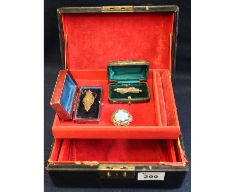 A leather cantilever jewellery box with red velvet interior containing a Victorian diamond set pin, a pearl bar brooch and a 