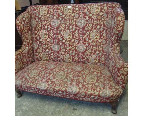 20th Century upholstered wing backed two seater sofa on cabriole legs, upholstered in foliate and shield shaped crests. (B.P.