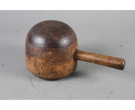 A stonemason's mallet, a Victorian ebonised bobbin turned footstool and a wooden model of a 16th century galleon, on wooden b