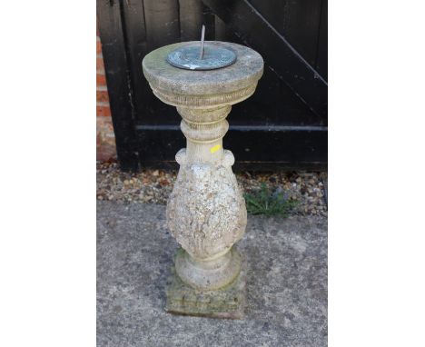 A cast stone sundial pillar with acanthus leaf decoration and a brass sundial 