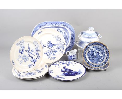 A 19th century blue and white sauce tureen and cover, a ladle and stand, two Davenport "Willow" pattern plates, 7 1/2" dia, o