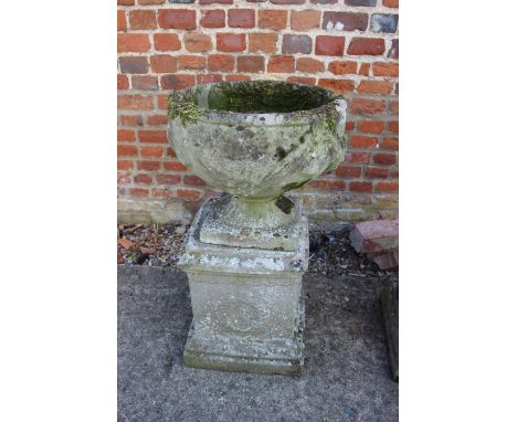 An antique cast stone planter with swag decoration, on square base, 29" high