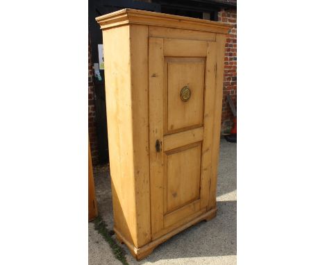 A late 19th century waxed pine cupboard enclosed panel door with brass grill, on bracket feet, 36" wide x 16" deep x 66" high