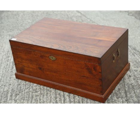 A teak trunk with brass side clips, 34" wide x 21" deep x 15" high 
