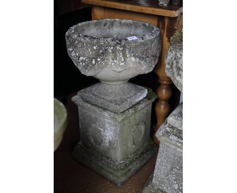 An antique cast stone planter with swag decoration, on square base, 29" high