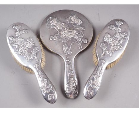 A Wang Hing 19th century Chinese export three-piece silver dressing table set, comprising two brushes and a mirror (mirror cr