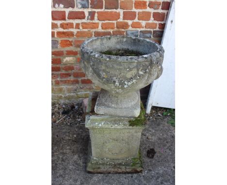 An antique cast stone planter with swag decoration, on square base, 29" high