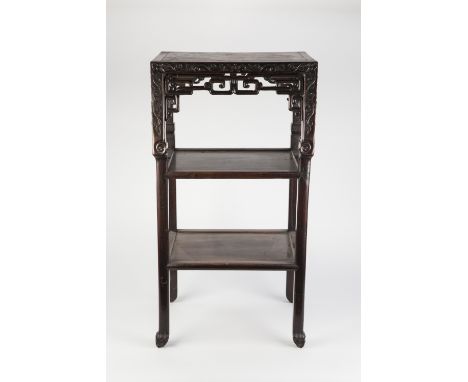 A LATE 19TH CENTURY CHINESE HARDWOOD THREE TIER STAND with marble inset top, having a scroll carved and pierced key-fret frie