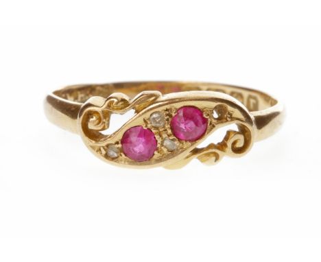 EARLY TWENTIETH CENTURY CREATED RUBY AND DIAMOND RING the pierced scroll bezel set with two round faceted created rubies and 