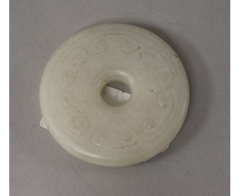 A Chinese white jade bi disc