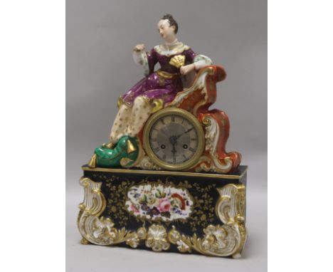 A Jacob Petit porcelain mantel clock, the circular Roman dial with silvered chapter ring, having figural surmount of a young 