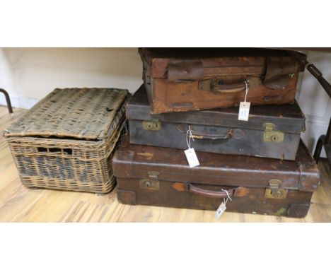 Three vintage leather suitcases and a wicker hamper