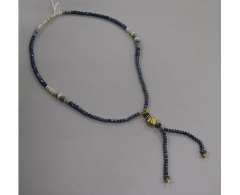 A white opal and facet cut sapphire bead drop tassel necklace with yellow metal spacers and diamond set yellow metal nugget, 