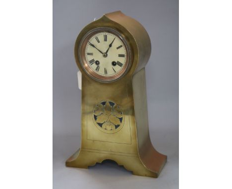 A brass-cased mantel clock in the Art Nouveau taste, having circular Roman dial and lancet-shaped case with foliate-pierced r