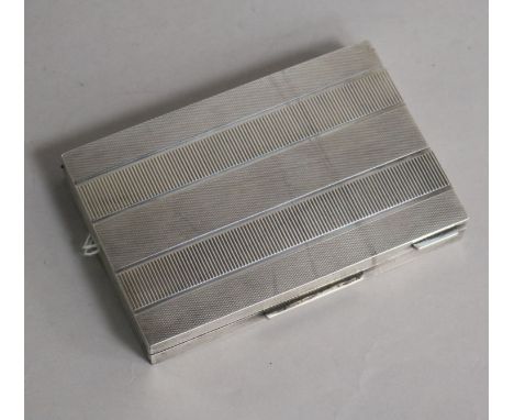 A Continental 800 standard silver rectangular compact, engine-turned, the hinged cover enclosing a fitted mirror, a comb comp