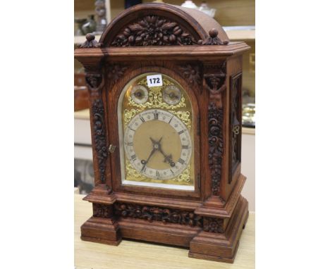A large carved oak mantel clock height 50cm