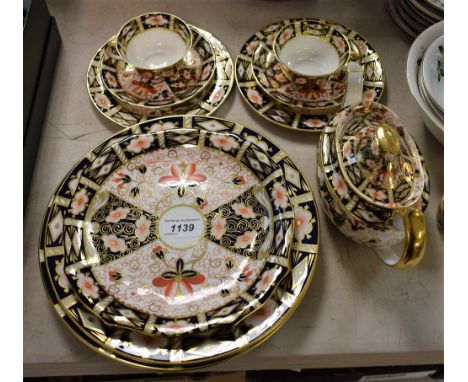 A Royal Crown Derby 2451 pattern Imari teapot, pair of cups, saucers and tea plates, bread and butter plate; a pair of 2451 p