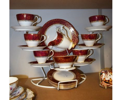 A Royal Albert six setting tea service, laurels on a ruby ground, printed marks