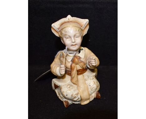 A German ceramic nodding head figure, of an Oriental girl, c.1890